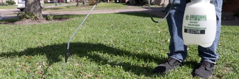 Applying Tenacity Herbicide to grass