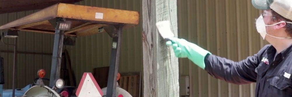 Painting FlySpot Bait on Barn Post