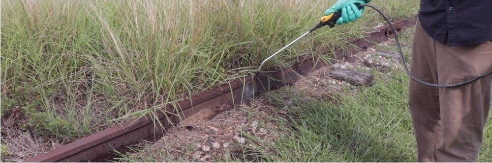 Applying Milestone Herbicide to railroad tracks