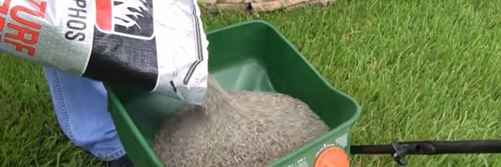 Pouring Nitrophos into a spreader