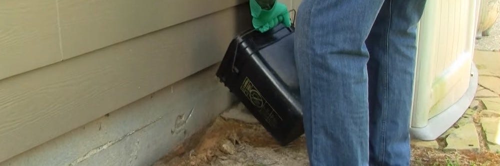 Pouring Bifen I/T into a termite trench